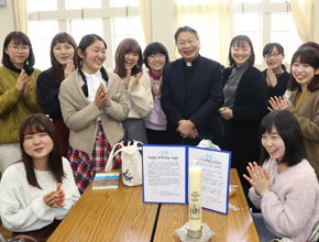 people smiling and posing with commemorative candles